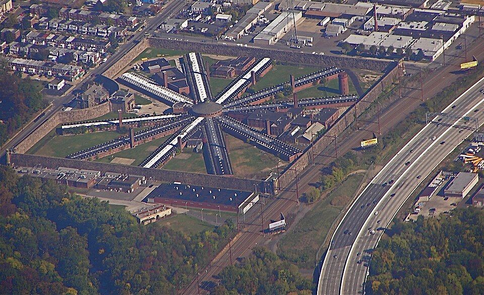 Aerial view of Holmesburg Prison in Philadelphia, showing its star-shaped cellblocks and surrounding grounds.