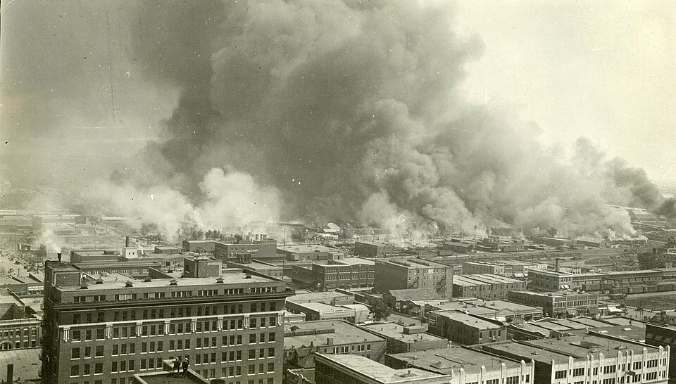 Smoke rising over buildings in Tulsa during the 1921 destruction of Greenwood