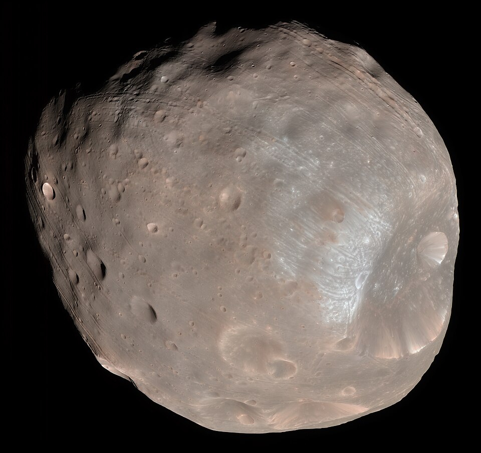 Color image of Mars’s moon Phobos with its cratered surface and grooves visible.